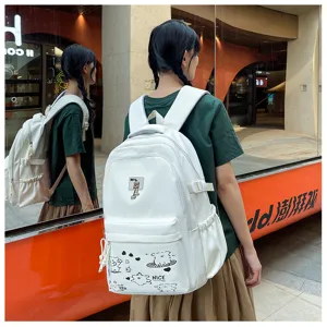 Detailed shot of a stylish white casual backpack with cute cartoon prints and side pockets.