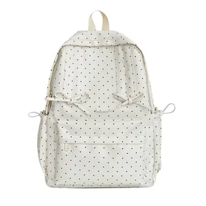 Cream white polka dot backpack cute Japanese style school bag for daily student commuting.