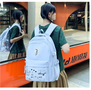 Light blue casual student backpack with cute cartoon doodles and front pocket for daily use.