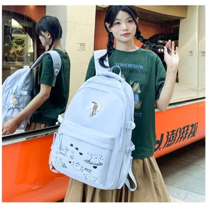 Casual light blue school backpack with cute bear pendant and print for daily student use.