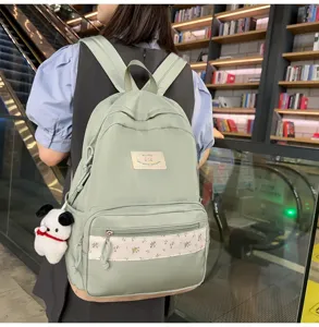 Casual green floral patchwork school backpack for women and students with cute dog pendant.