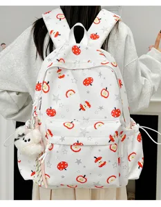 Cute cartoon printed white canvas backpack with plush charm, perfect for daily school and travel.