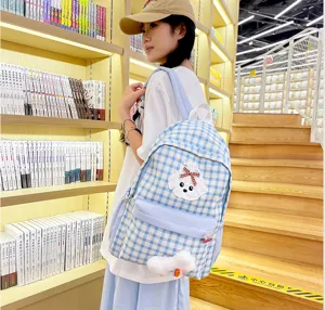 Blue and white plaid backpack for women, large capacity cute student school bag with dog charm.