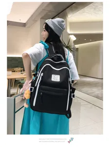 Casual daily student backpack in stylish contrasting colors with large capacity for travel.