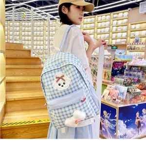Casual student plaid backpack featuring cute dog patch and spacious design for daily school use.