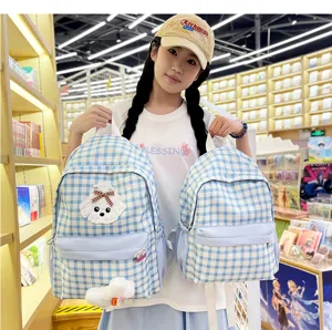 Cute blue plaid school backpack for teenage girls with puppy patch and large capacity design.