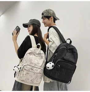 Casual student backpack with Chinese bamboo print and panda pendant for school travel daily use.