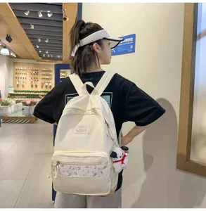 Korean style floral patchwork backpack for women, casual campus school book bag for daily commute.