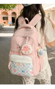 Japanese casual large capacity pink school backpack detail, rear view with cute charms.