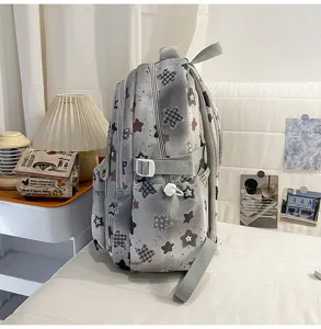 Detail view of casual grey star print school backpack with multi compartments and side pockets.