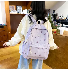 Detail view of the cute bow pattern lightweight backpack in a stylish indoor setting.