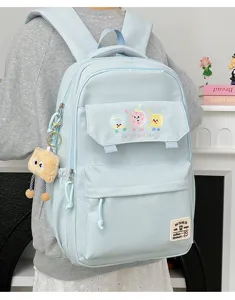 Close-up detail of the light blue student backpack featuring cute cookie prints and pockets.