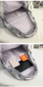 Backpack interior detail view showcasing multiple storage compartments and large capacity space.