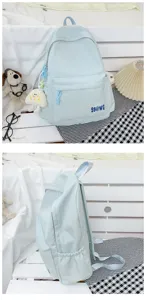 Close-up detail of the light blue casual backpack, showing the front pocket and side design.