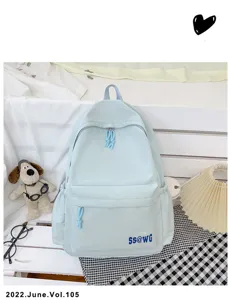 Close-up detail view of light blue campus backpack featuring front pocket and zipper design.