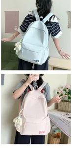 Detailed view of casual canvas backpack with cute plush pendant, lightweight and versatile.