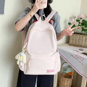 Japanese ins style pink campus backpack for women, lightweight casual travel school bag with charm.