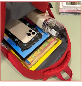 Sac à dos d'école rouge grande capacité, idéal pour les trajets quotidiens des étudiants.