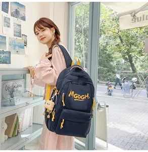 Korean style minimalist large capacity casual canvas backpack with cute pendant for daily use.