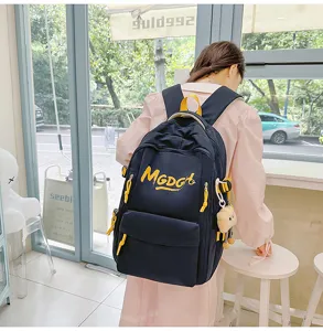 Korean style casual large capacity backpack with yellow zippers and cute pendant decor.