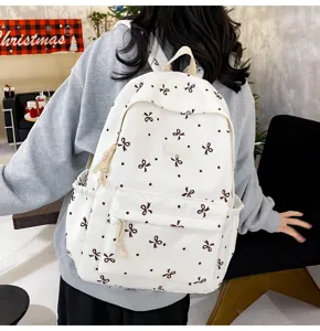 Cute bow print canvas backpack for daily school and casual use, large capacity bookbag.