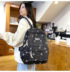 Casual minimalist backpack with cute bow print, lightweight daily school bag for students.