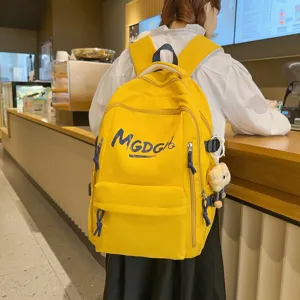 Stylish yellow casual backpack with large capacity, perfect for daily commuting and travel.
