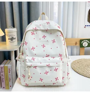 Cute pink bow detail on white casual backpack, cozy bedroom scene showing large daily capacity.