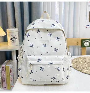 White casual canvas backpack with blue bow and dot pattern, large capacity school bag.