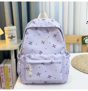 Purple casual backpack with bow dot pattern, lightweight school bag for daily commute.