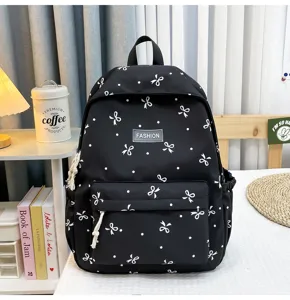 Black backpack with white bows and polka dots, casual school bag, large capacity daily use.
