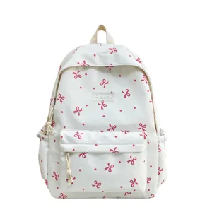 Cute white backpack with red bows and polka dots, casual school daypack for teens.