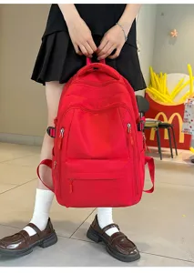 Vue détaillée d'un grand sac à dos de loisirs rouge pour étudiants avec multiples poches.