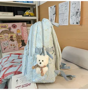 Light blue quilted student backpack with cute plush bear pendant, spacious laptop daypack for campus.
