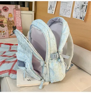 Unisex large capacity commuter backpack, light blue star quilted school bag for students.