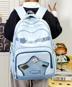 Zaino scolastico azzurro carino per bambini con grande capacità, tasca in rete e bel design.