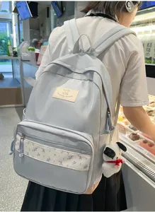 Korean style floral patchwork backpack for students, casual commuter school bag with cute pendant.