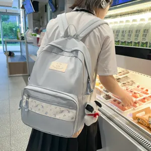 Light blue school backpack with floral patchwork, stylish commuter daypack for students.