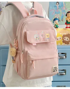 Cute pink aesthetic school backpack for teen girls, large capacity casual daypack bag.