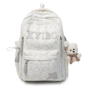 Casual white student backpack with textured pattern and cute bear pendant for daily commute.