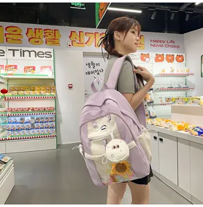 Detail shot of light purple ita backpack featuring transparent pocket and cute plush charm.