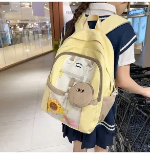 Cute yellow Ita backpack detail view, featuring clear front pocket and kawaii charms design.