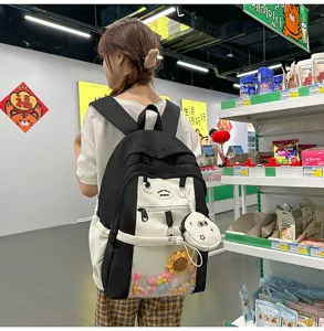 Japanese style color block ita backpack with transparent pocket and cute hanging plush charms.