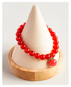 Natural red agate beaded single-circle bracelet with cute peach pendant jewelry detail view.