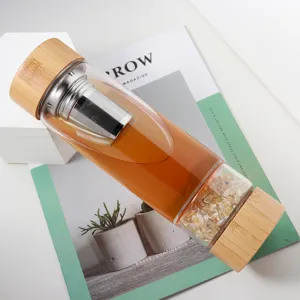Natural crystal glass water bottle with bamboo lids, stainless steel infuser detail view.