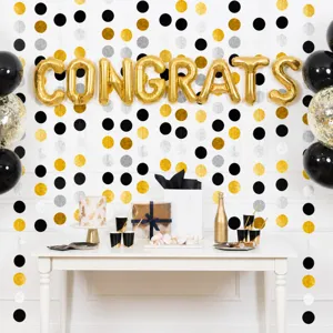 Detail view of black gold silver circle dot garland hanging party decoration backdrop.