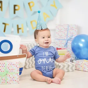 Kids birthday party hat and romper set, cute blue baby first birthday celebration outfit.