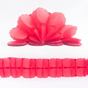 Red paper clover garland detail view for party decoration and wedding backdrop setup.