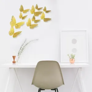 Vue détaillée des stickers muraux papillons ajourés 3D dorés, parfaits pour déco maison et fêtes.