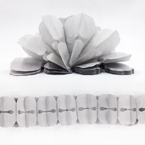 Closeup detail view of white paper garland and hanging decoration for party and wedding styling.